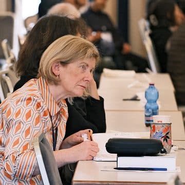 Conference attendee taking notes